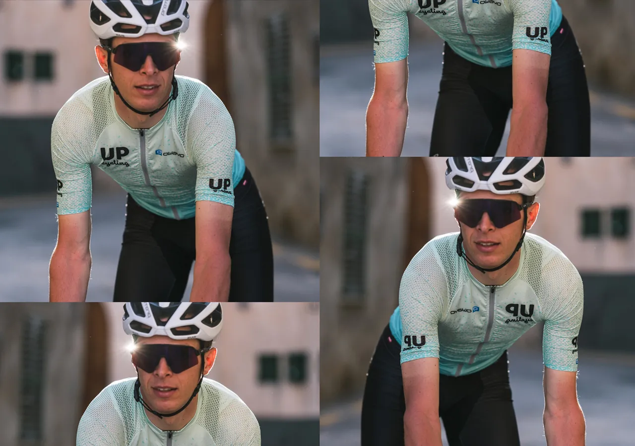 Un ciclista con una camiseta azul claro con estampado, con el logo 'UP cycling' y el nombre de marca 'owayo' en el pecho, montando en bicicleta.